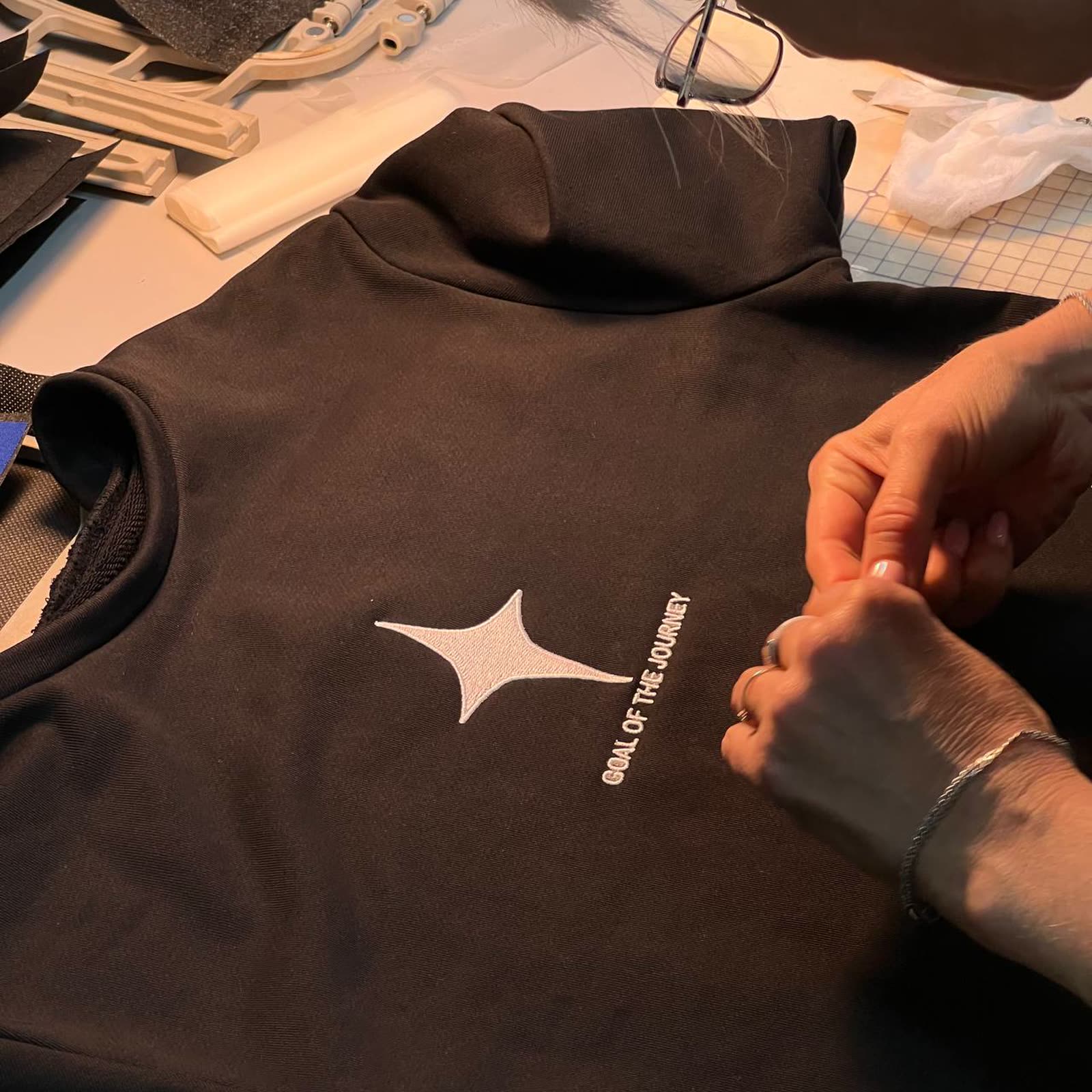 Embroidered white star on black fabric, the HOME collection in production